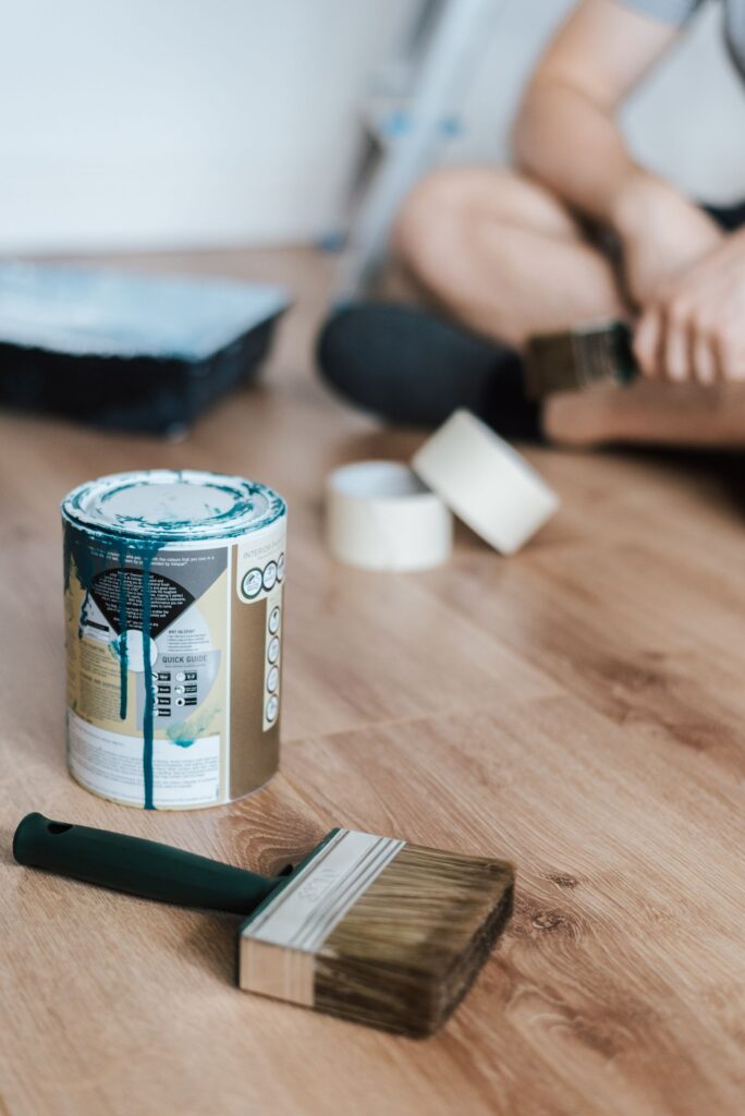 core-values Worker applying finish to a refinished hardwood floor